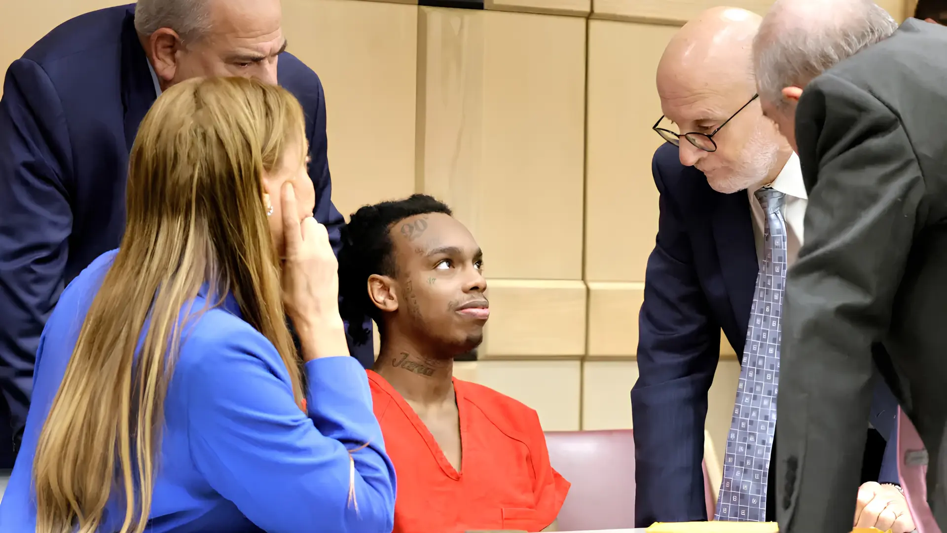 ynw melly with a bunch of lawyers in a court room trail.