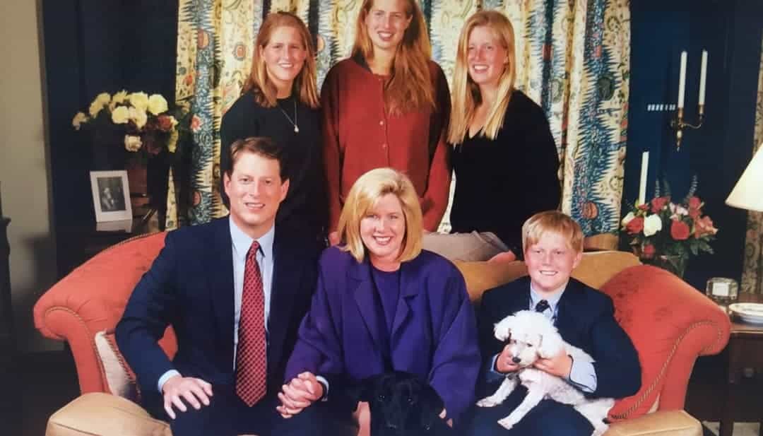 a family photo of al gore his wife children and pets on a sofa