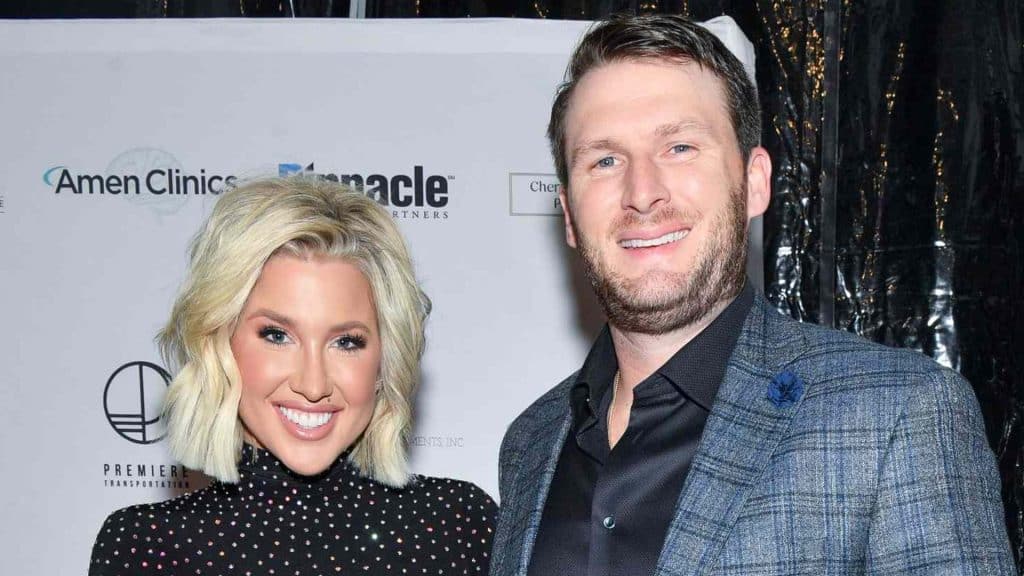 robert shiver with savannah chrisley at a public event both smiling for the camera