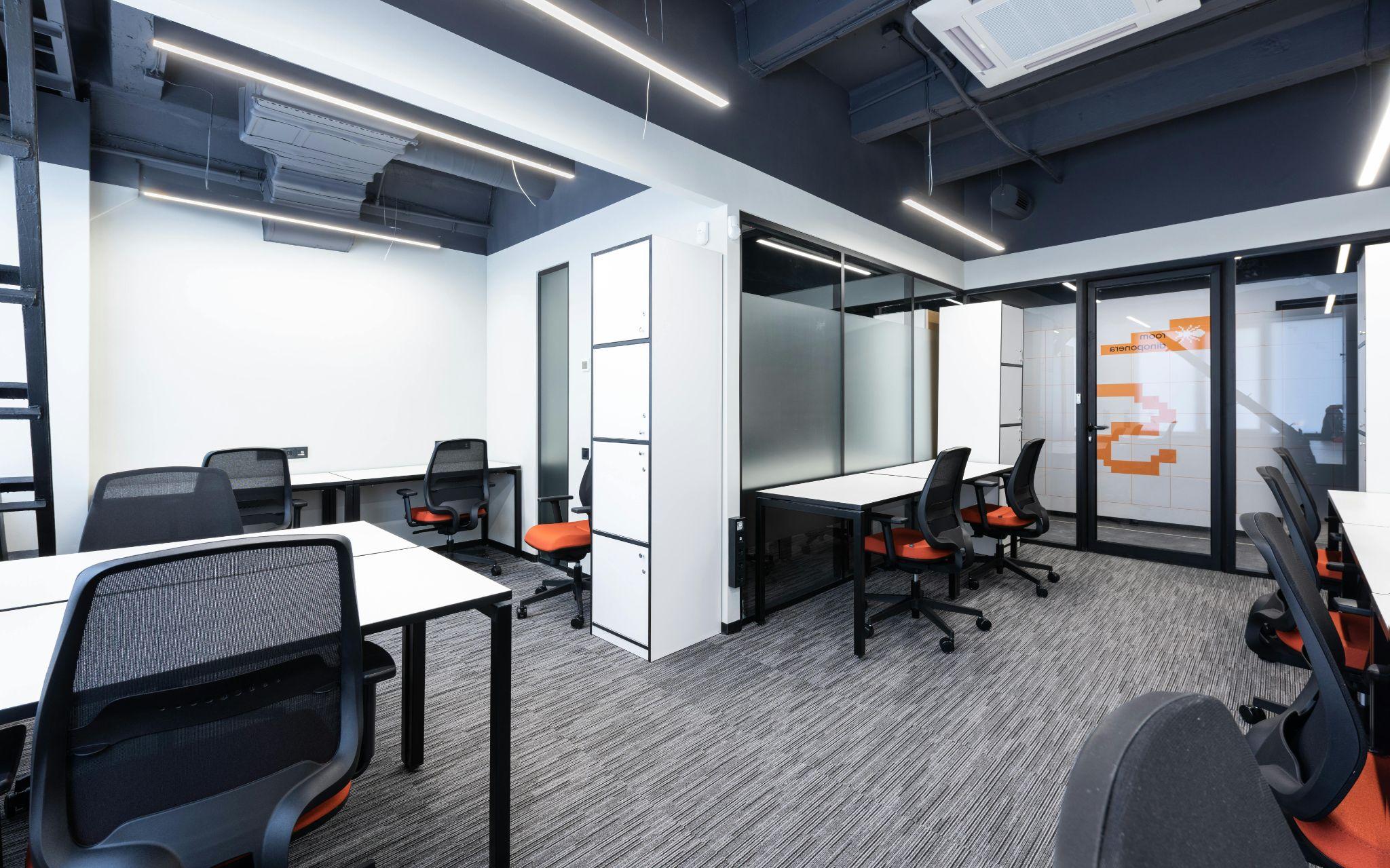 Open space office with tables and chairs.