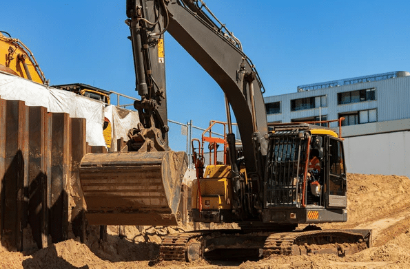 Excavator digging at construction site.