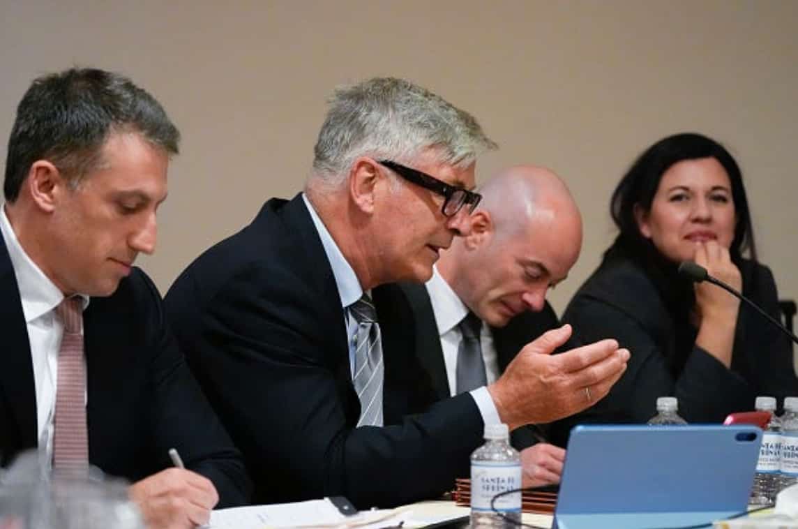 alec baldwin speaking beside attorney alex spiro at a legal hearing