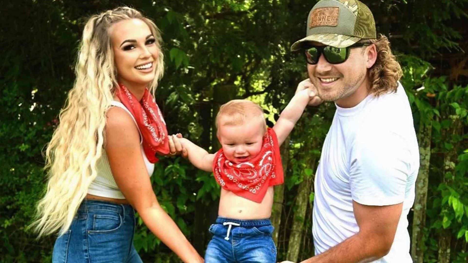 morgan wallen and katie smith posing outdoors with their son smiling in a family photo.jpeg