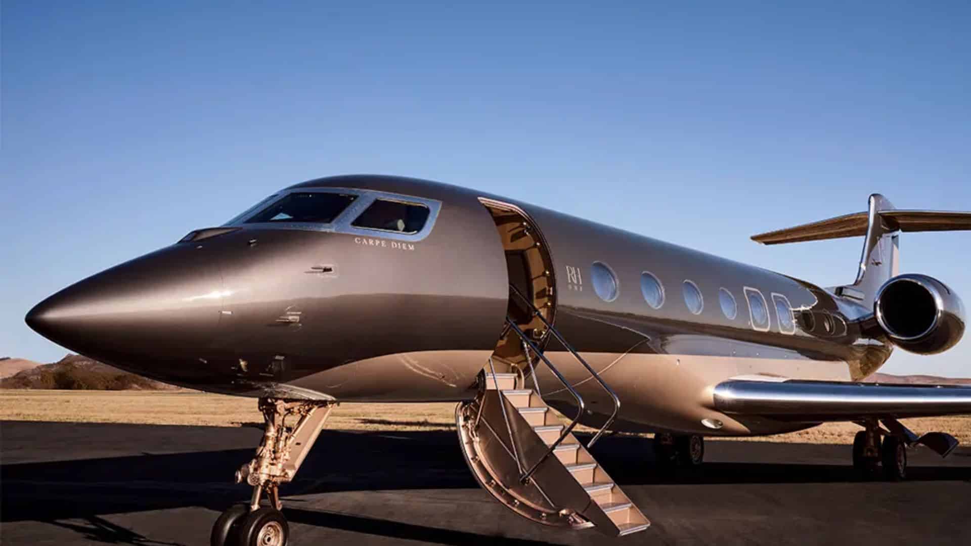 A Sleek Silver Private Jet on the Runway, Described as Elon Musk’s Private Jet, Named “carpe Diem.”
