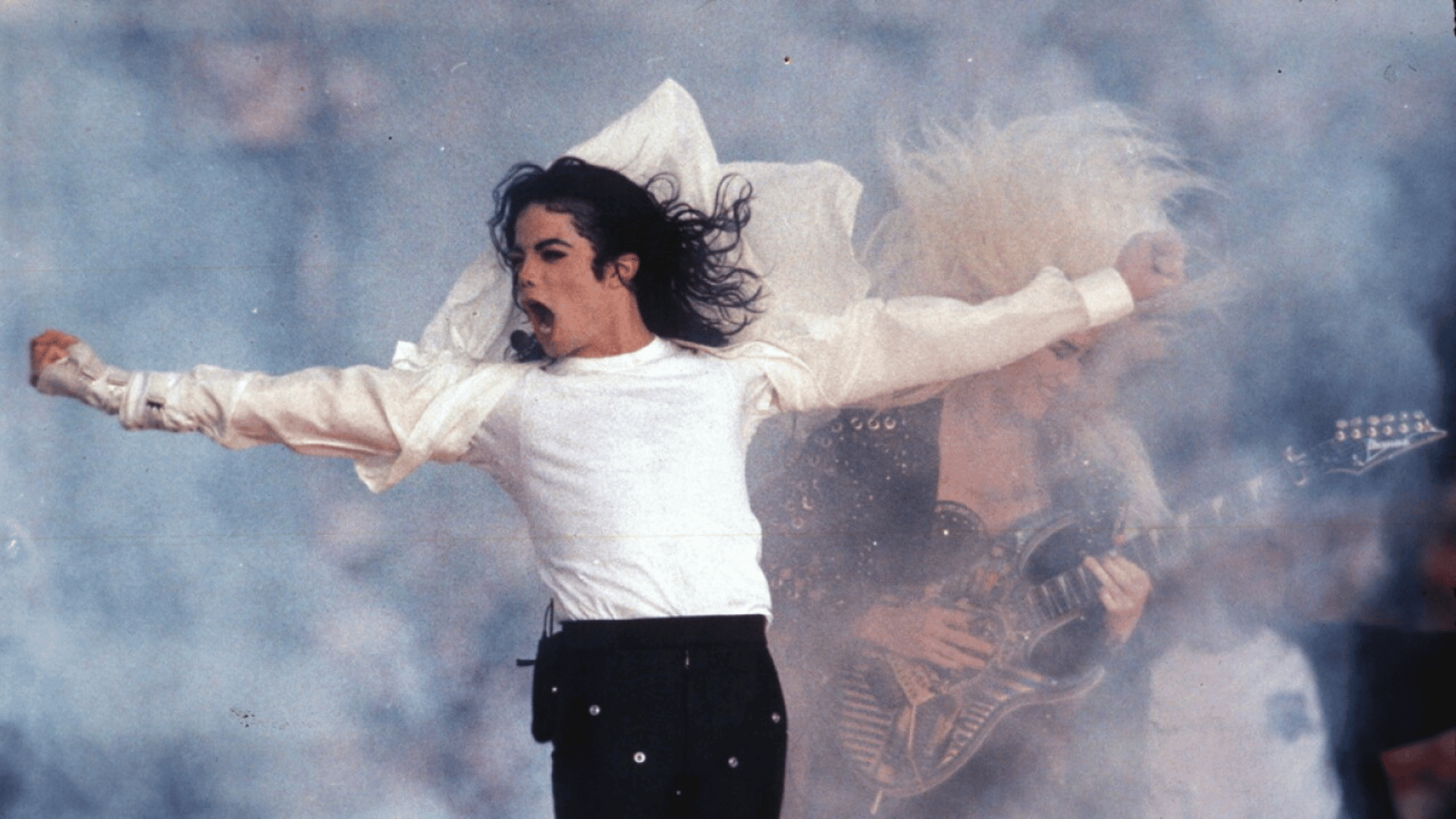 Michael Jackson performing live on stage during a concert.