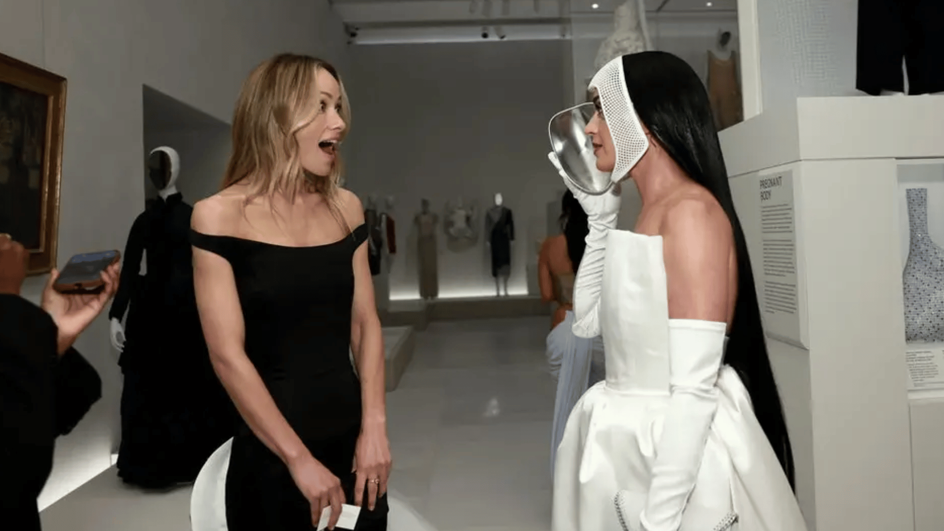 Olivia Wilde enjoys Katy Perry's futuristic mask courtesy of Stella McCartney.