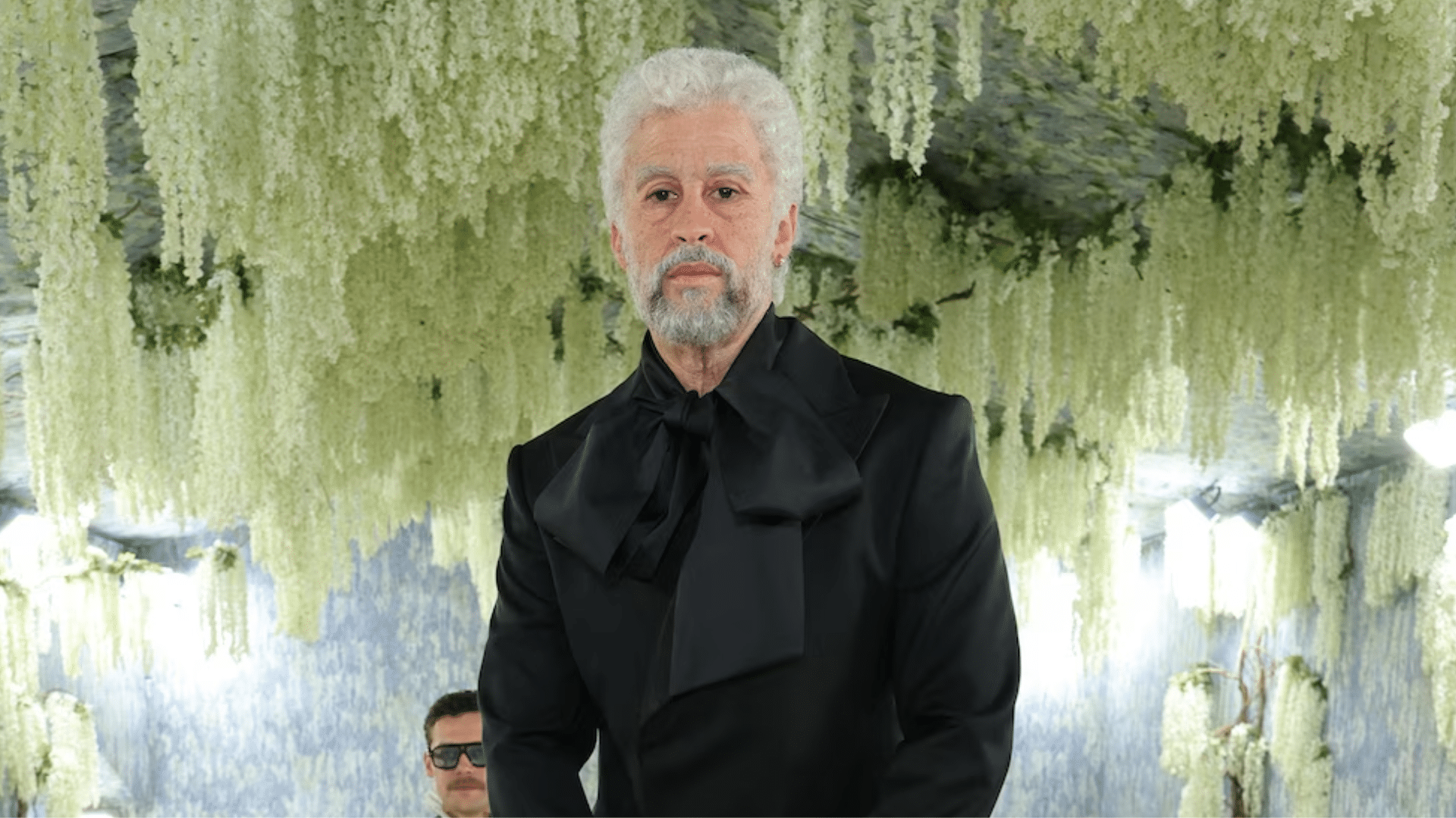 Bad Bunny at Met Gala 2026 in aging prosthetic makeup and black tailored look inspired by Costume Art exhibition theme.