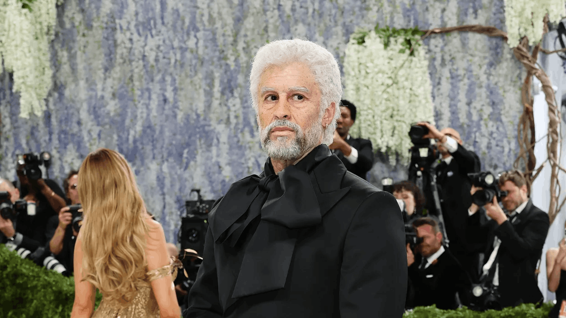 Bad Bunny wearing a custom Zara tuxedo and prosthetics aging himself 53 years at the Met Gala 2026.