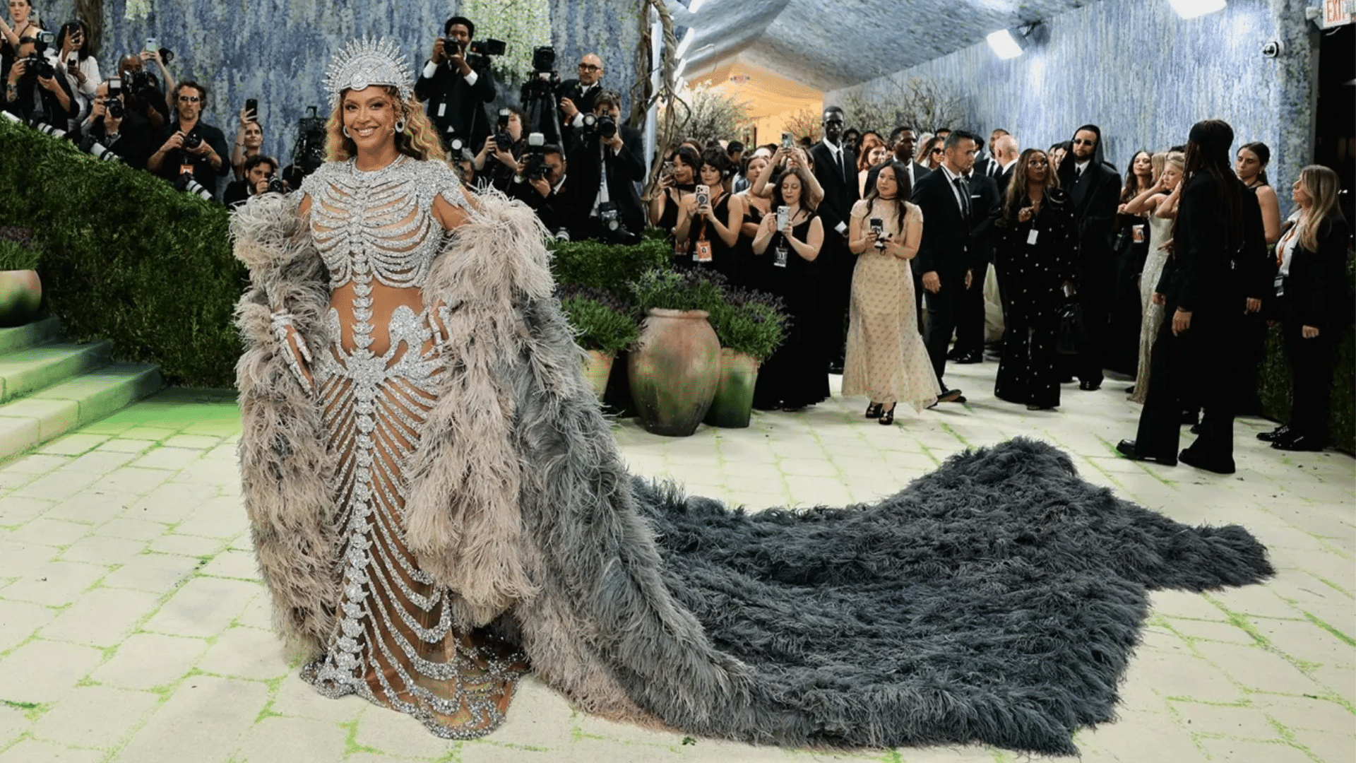 Beyoncé at Met Gala 2026 in diamond-encrusted Olivier Rousteing gown with feathered ombré cape and sculptural headpiece
