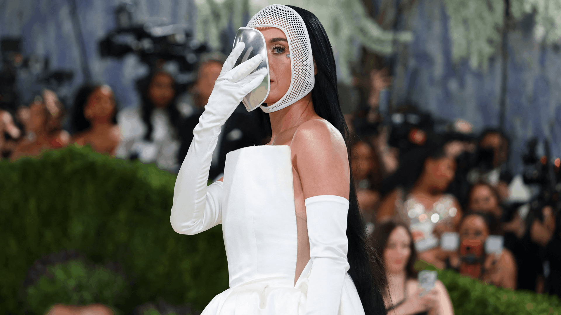 Katy Perry in a chrome mask and a gown by Stella McCartney, more costume than art at the Met Gala.