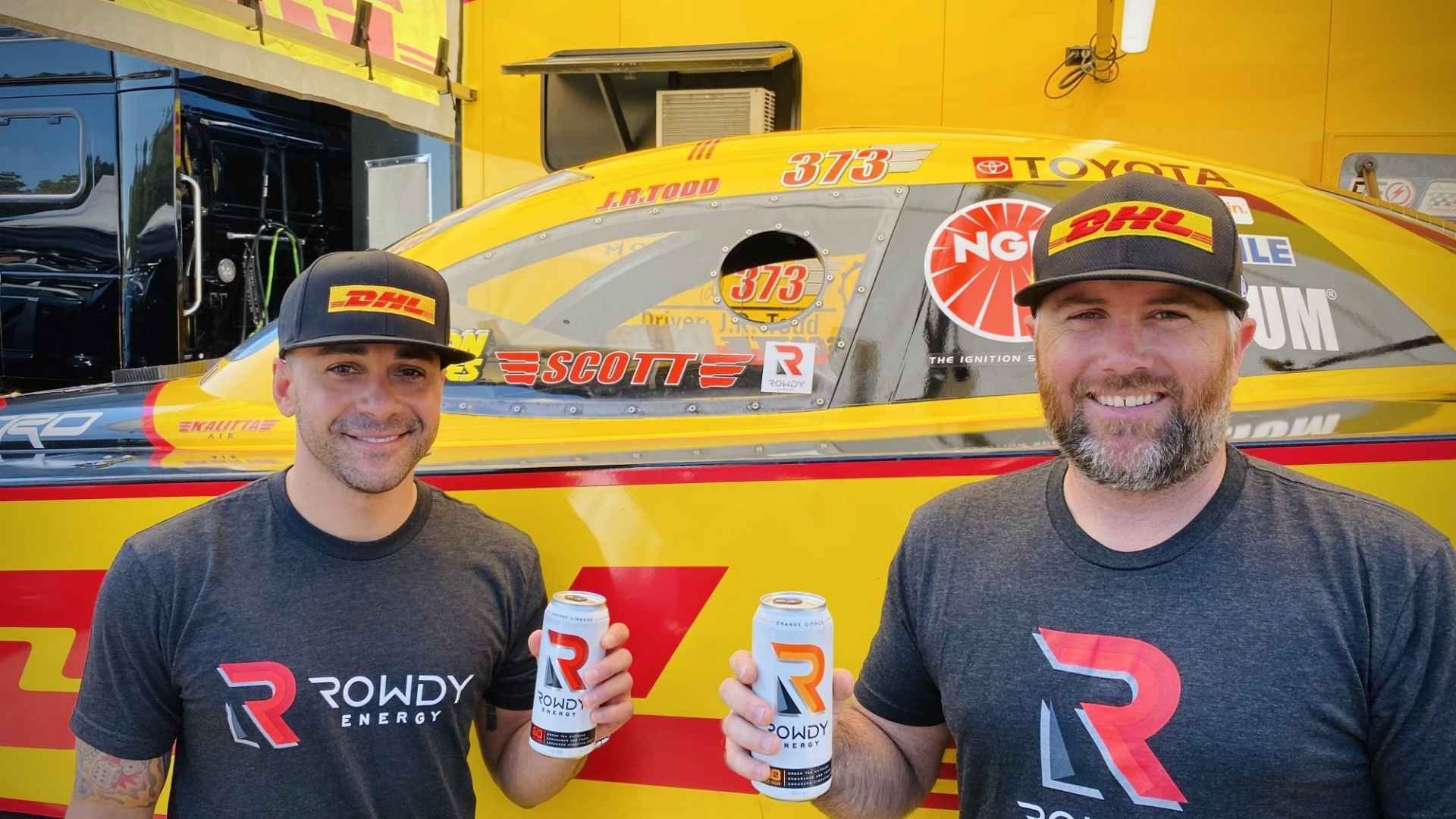 Kyle Busch business partnership promoting Rowdy Energy beside a race car.