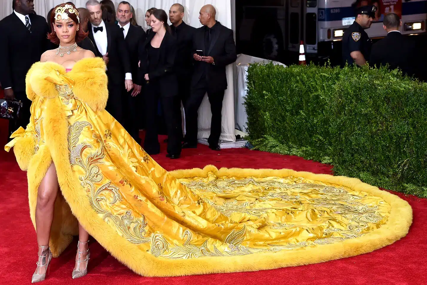 Rihanna wearing a yellow fur-trimmed Guo Pei couture gown at the 2015 Met Gala.