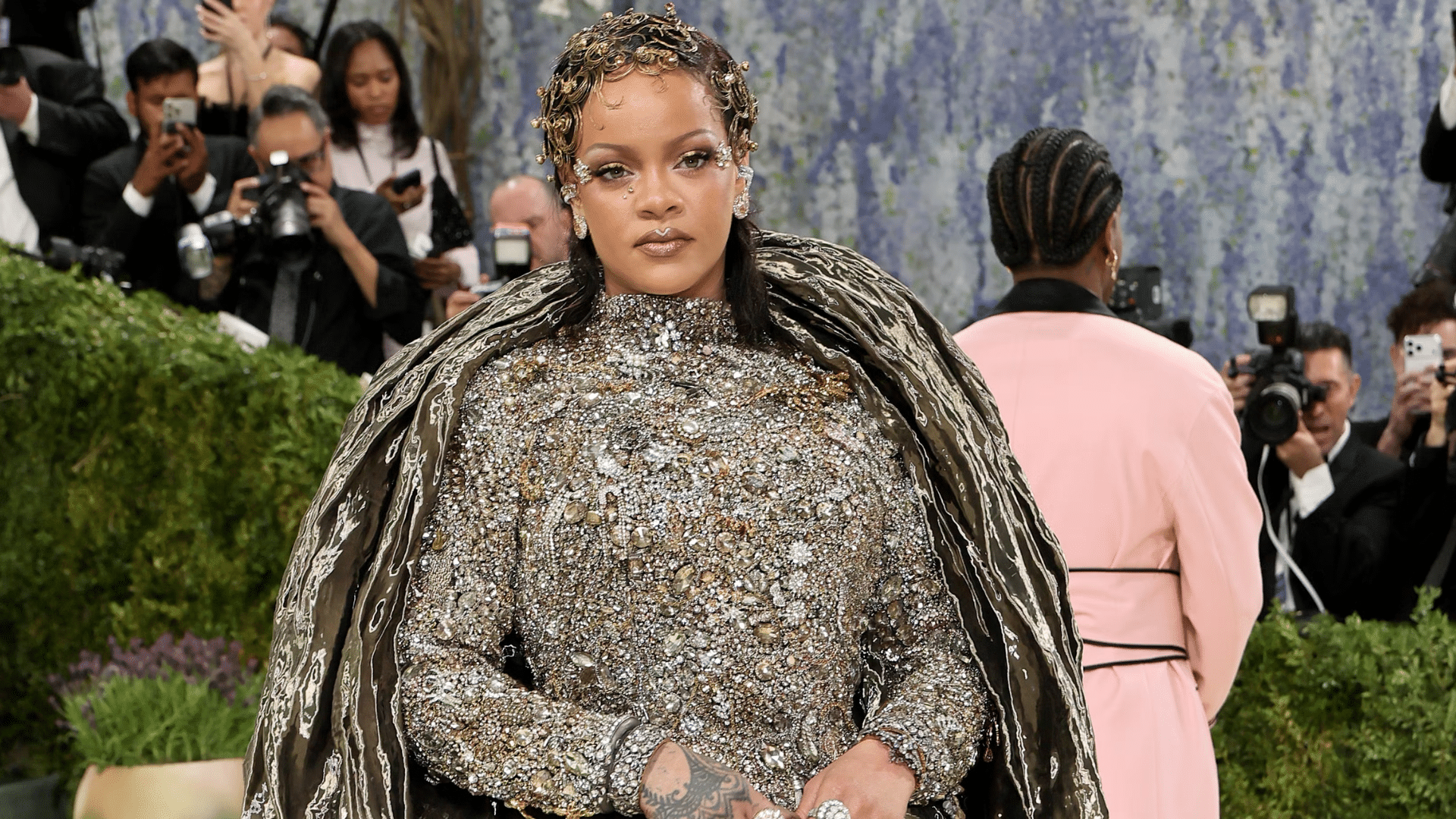Rihanna at Met Gala 2026 in Maison Margiela Artisanal gown with gemstone embroidery and bronze sculptural shroud.