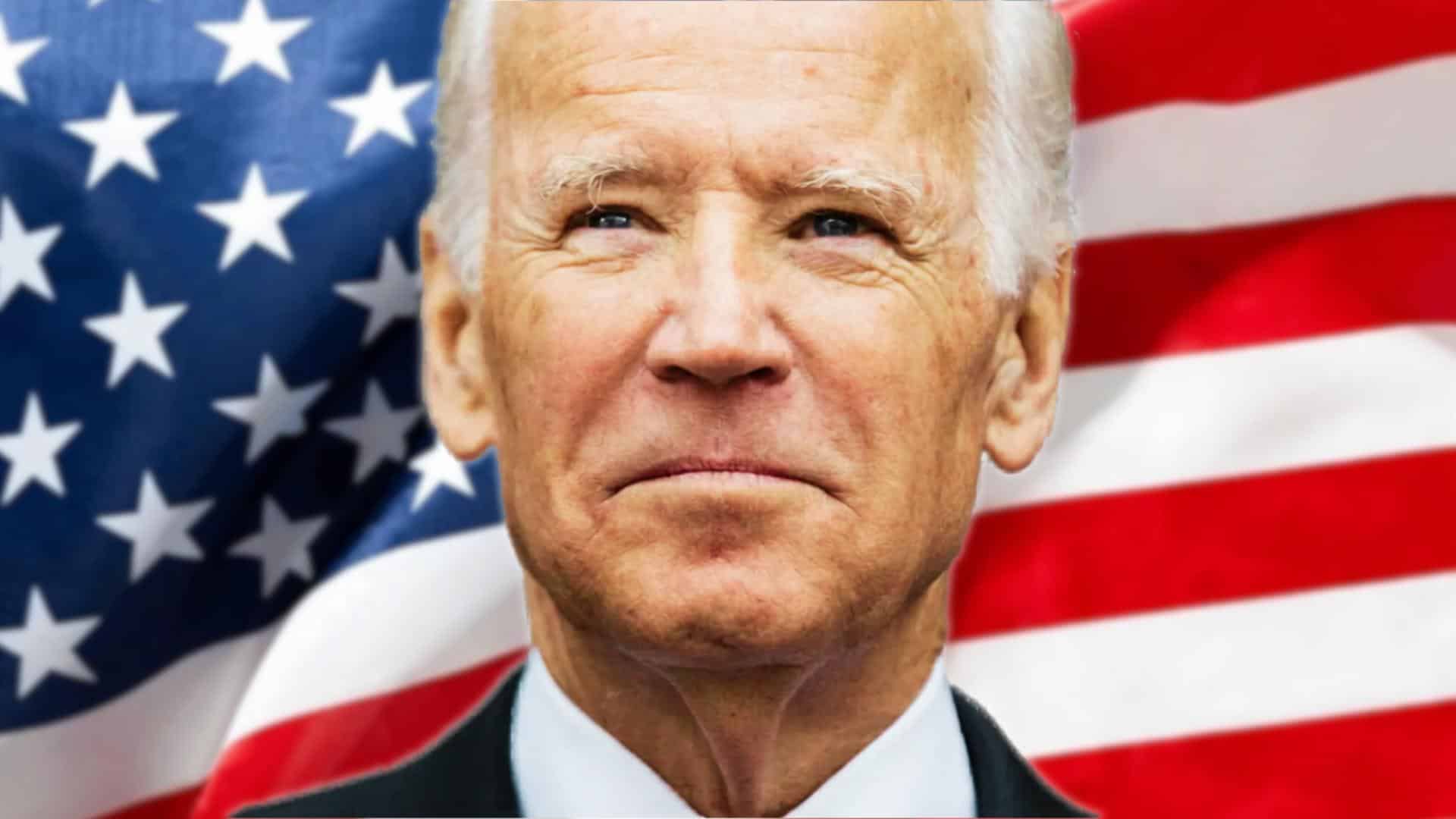 Joe Biden close-up portrait with U.S. flag in background, serious expression, presidential image.