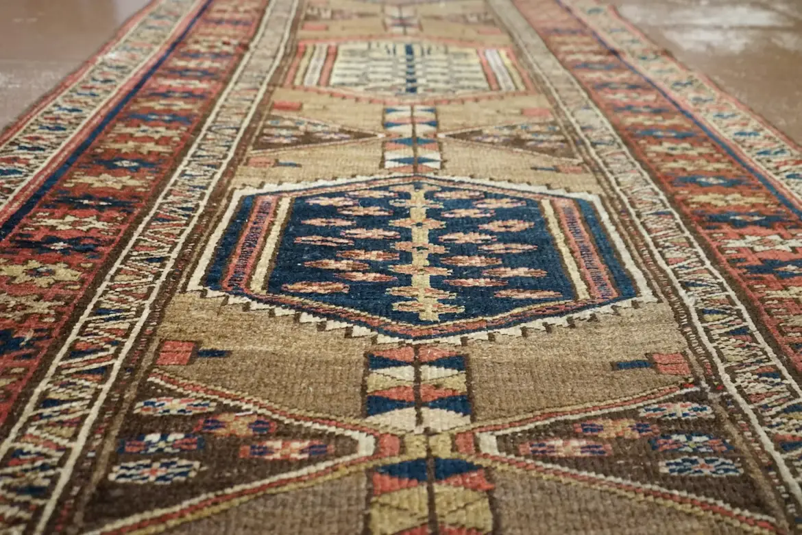 Close-up of a patterned, multicolored Persian rug with intricate geometric designs