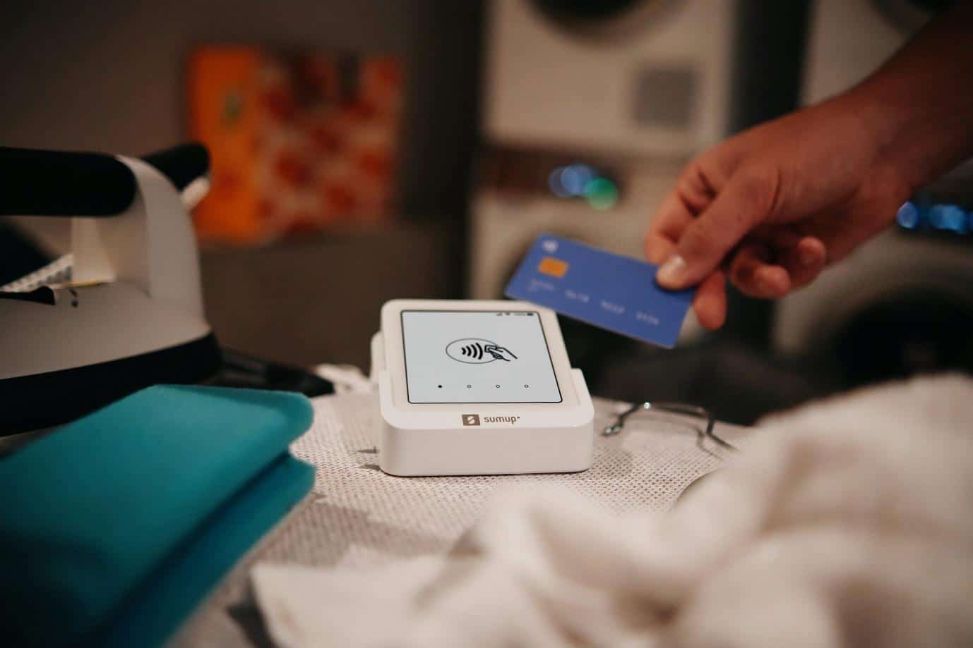 Paying with a credit card at a laundromat.