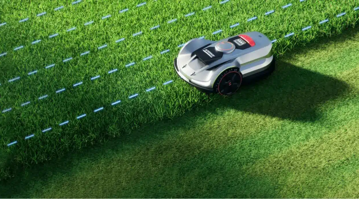 Robotic lawn mower cutting grass in sunny yard with precision lines and lush green turf