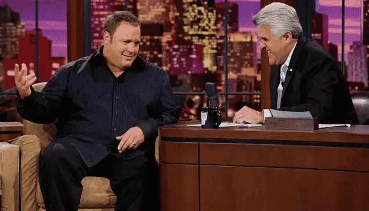 Kevin James gesturing while speaking with Jay Leno on a talk show, a highlight item for kevin james net worth.