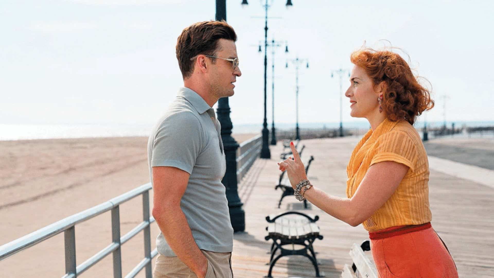 Kate Winslet and Justin Timberlake facing each other on a seaside boardwalk in Wonder Wheel