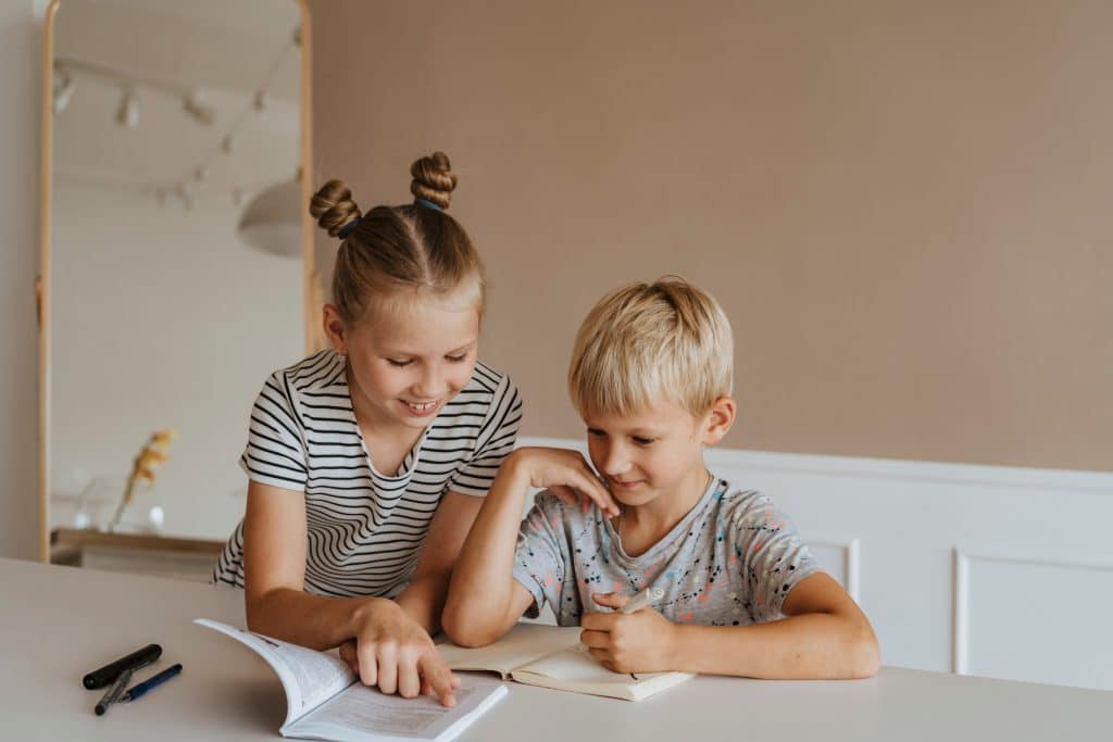 Two children sitting together and studying